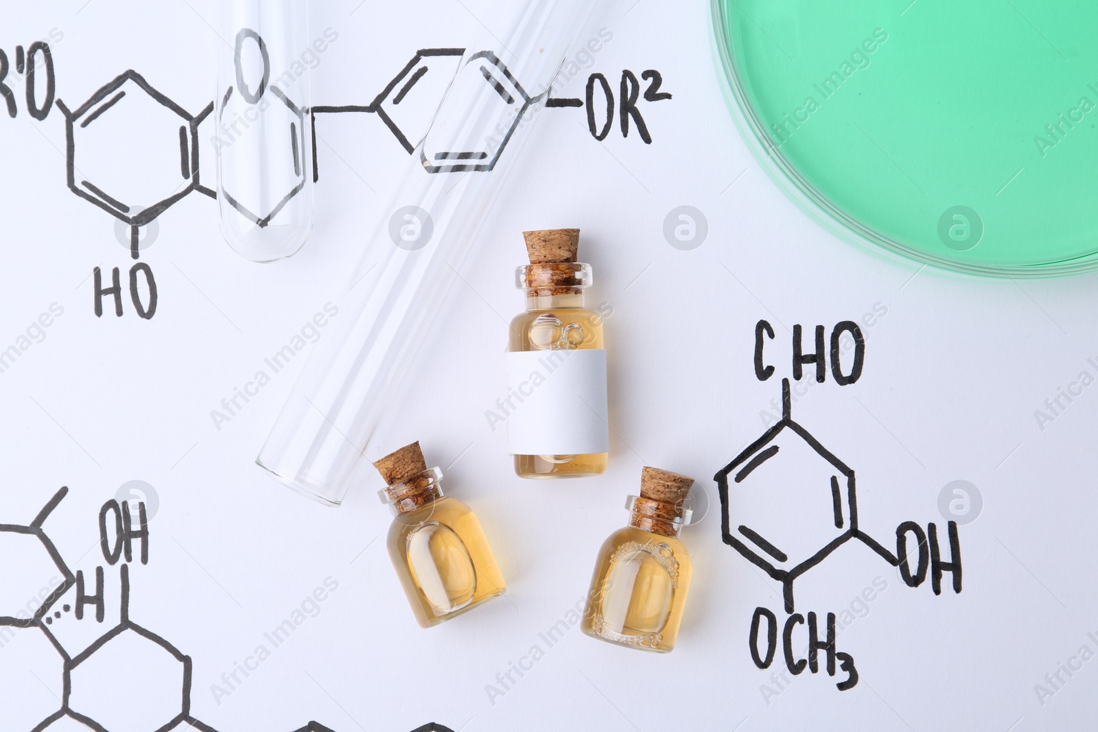 Bottles of cosmetic products, test tubes and Petri dish of sample on paper with chemical formulas, flat lay Photo of Bottles of cosmetic products, test tubes and Petri dish of sample on paper with chemical formulas, flat lay