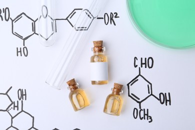Photo of Bottles of cosmetic products, test tubes and Petri dish of sample on paper with chemical formulas, flat lay