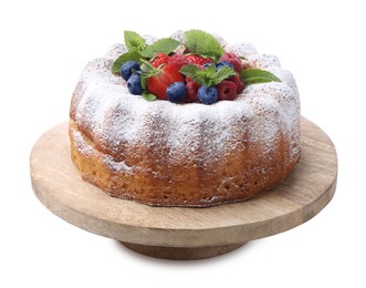 Photo of Tasty Bundt cake with powdered sugar and berries isolated on white