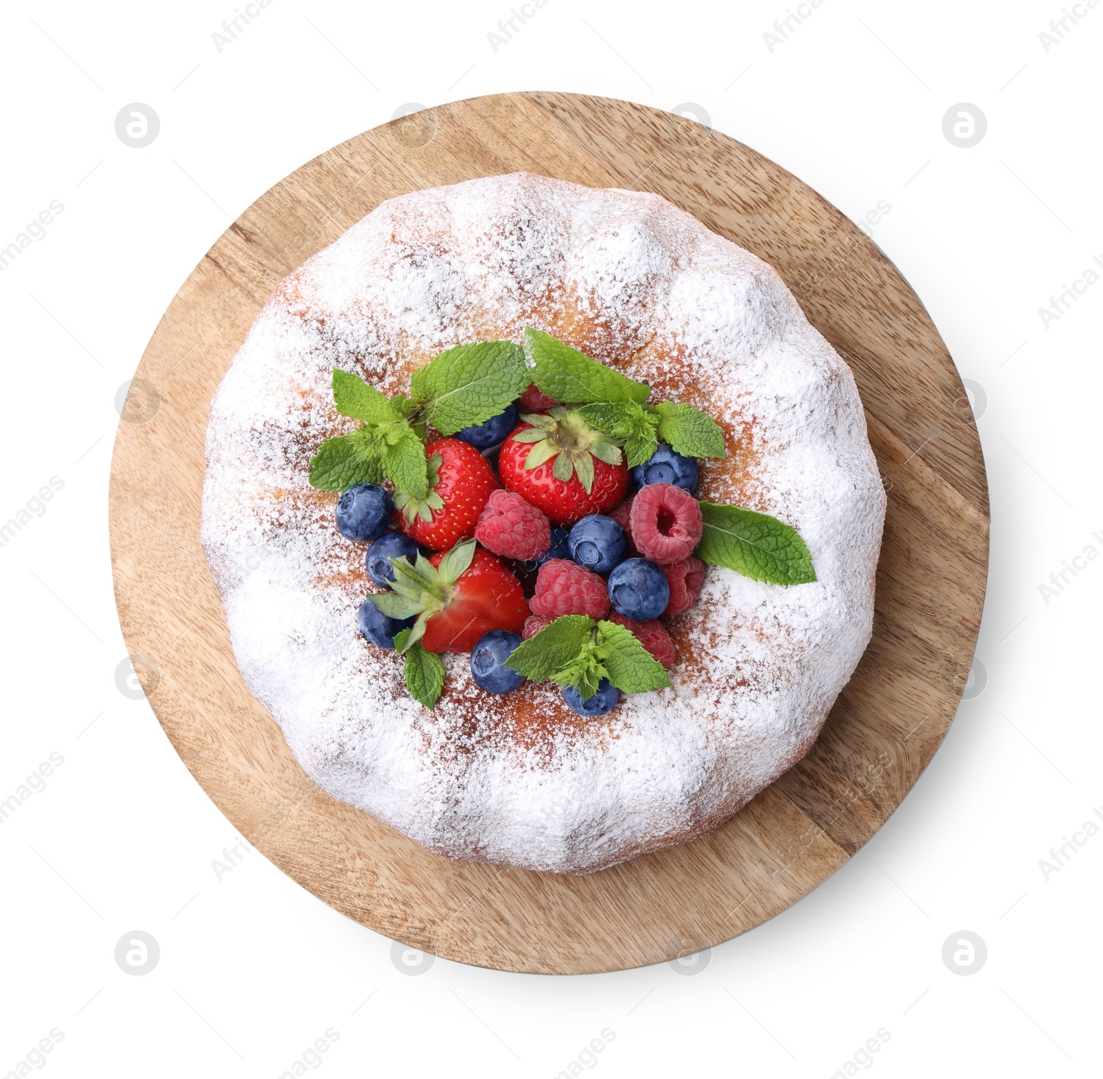 Tasty Bundt cake with powdered sugar and berries isolated on white, top view Photo of Tasty Bundt cake with powdered sugar and berries isolated on white, top view