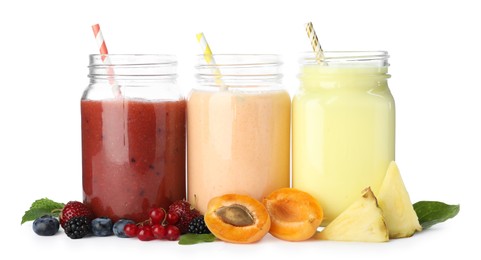 Photo of Superfood. Different tasty smoothies in mason jars and ingredients isolated on white