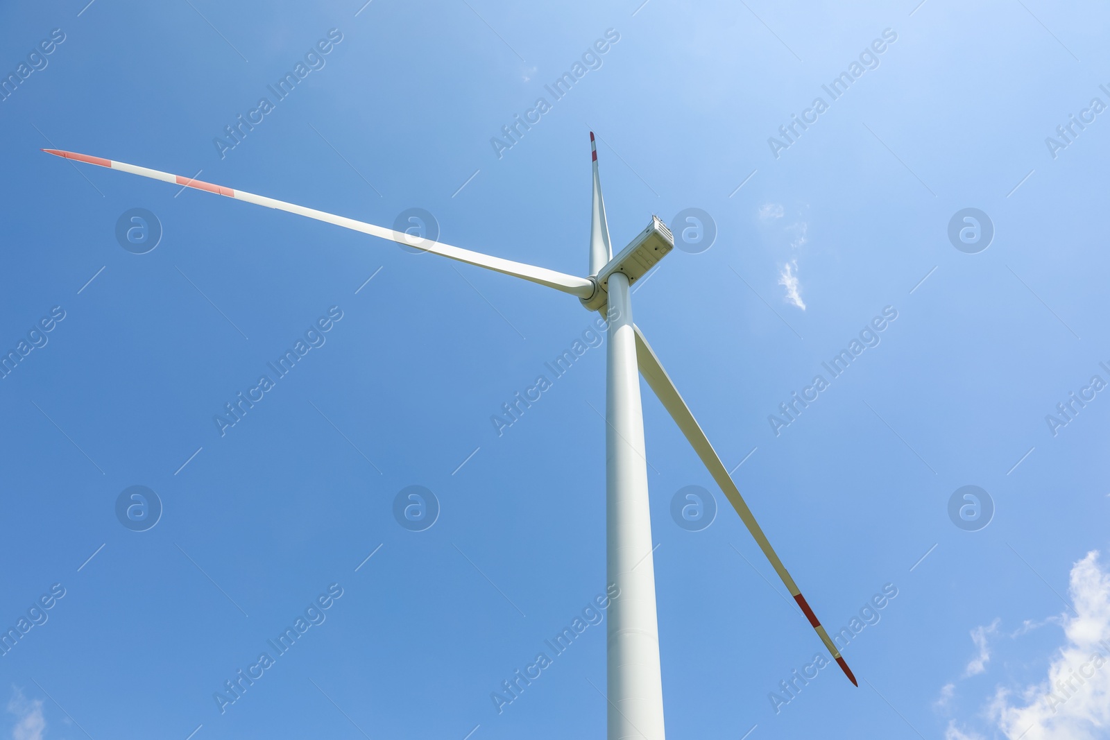 Modern wind turbine against blue sky, low angle view Photo of Modern wind turbine against blue sky, low angle view