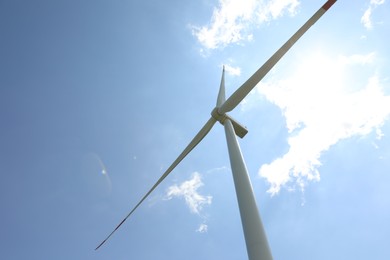 Photo of Modern wind turbine against blue sky, low angle view. Space for text