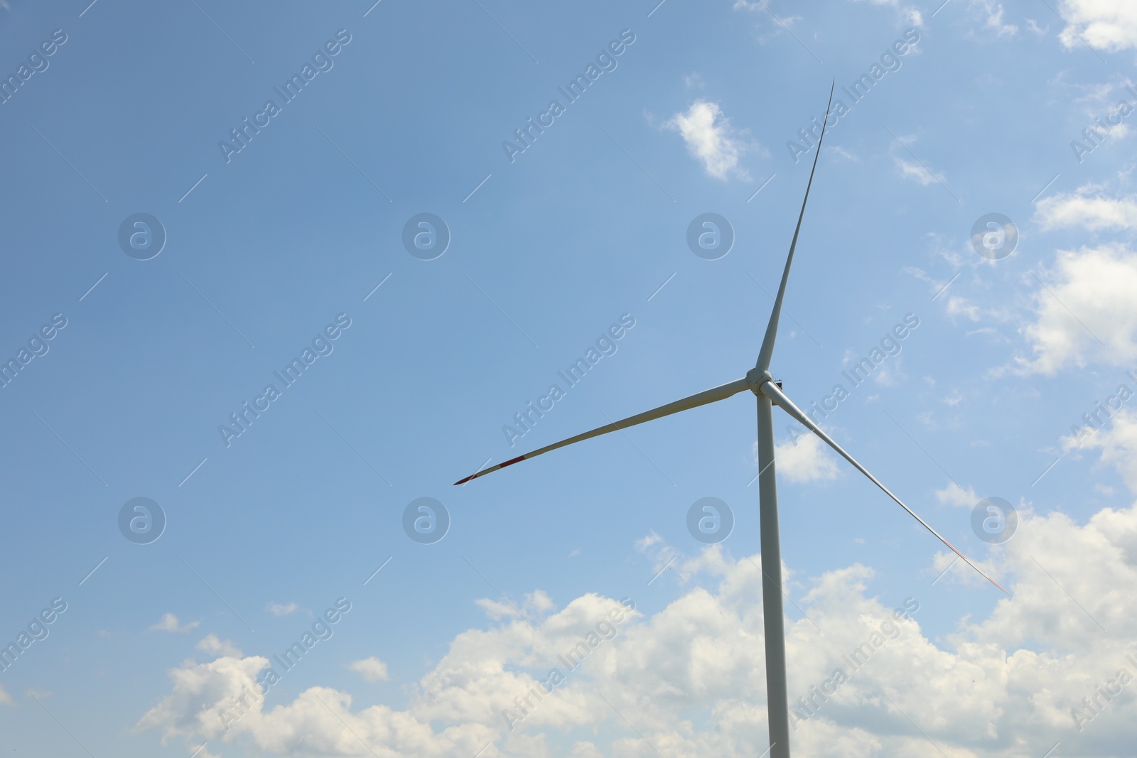 Modern wind turbine against blue sky, closeup Photo of Modern wind turbine against blue sky, closeup
