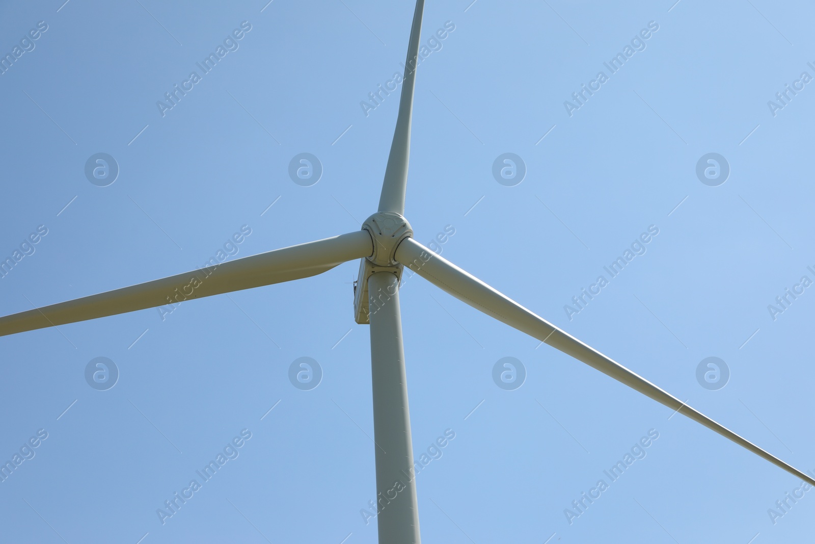 Modern wind turbine against blue sky, closeup Photo of Modern wind turbine against blue sky, closeup