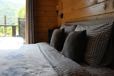 Photo of Comfortable bed near window in hotel room