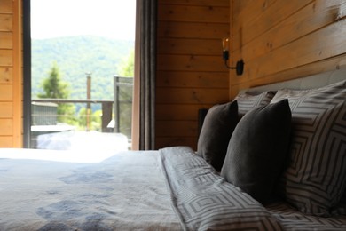 Photo of Comfortable bed near window in hotel room
