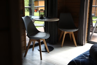 Photo of Table and chairs in stylish hotel room