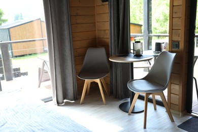 Photo of Table and chairs in stylish hotel room