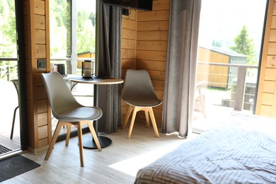 Photo of Table and chairs in stylish hotel room