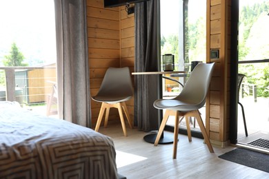 Photo of Table and chairs in stylish hotel room