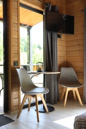 Photo of Table and chairs in stylish hotel room