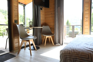 Photo of Table and chairs in stylish hotel room