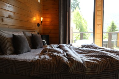 Photo of Comfortable bed near window in hotel room
