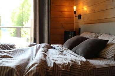Photo of Comfortable bed near window in hotel room