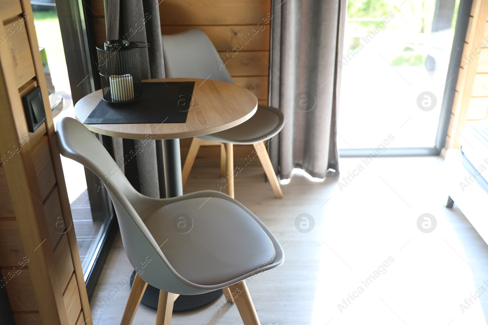 Table and chairs in stylish hotel room. Space for text Photo of Table and chairs in stylish hotel room. Space for text