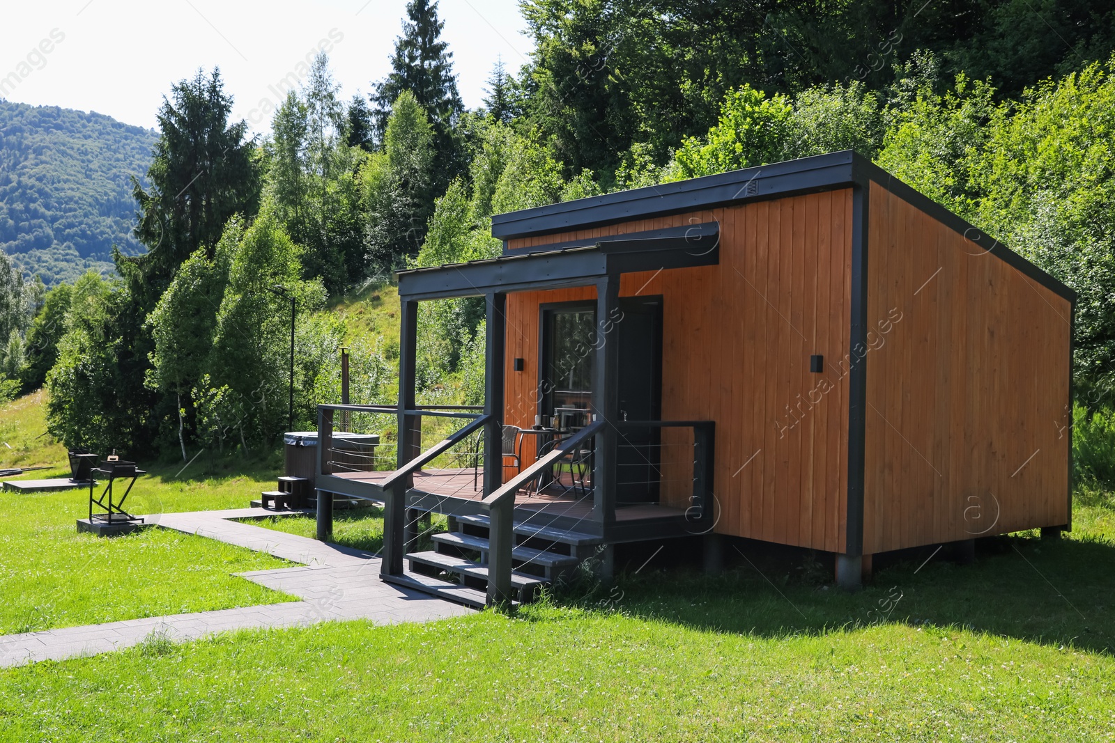 Stylish wooden cottage near forest at luxury resort Photo of Stylish wooden cottage near forest at luxury resort
