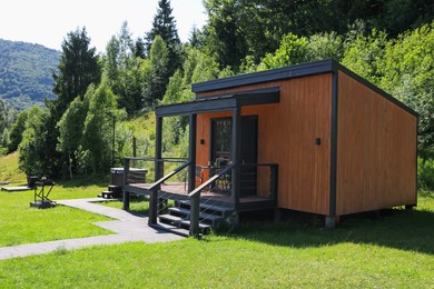Photo of Stylish wooden cottage near forest at luxury resort