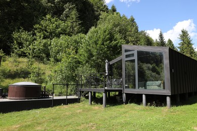 Photo of Stylish wooden cottage near forest at luxury resort