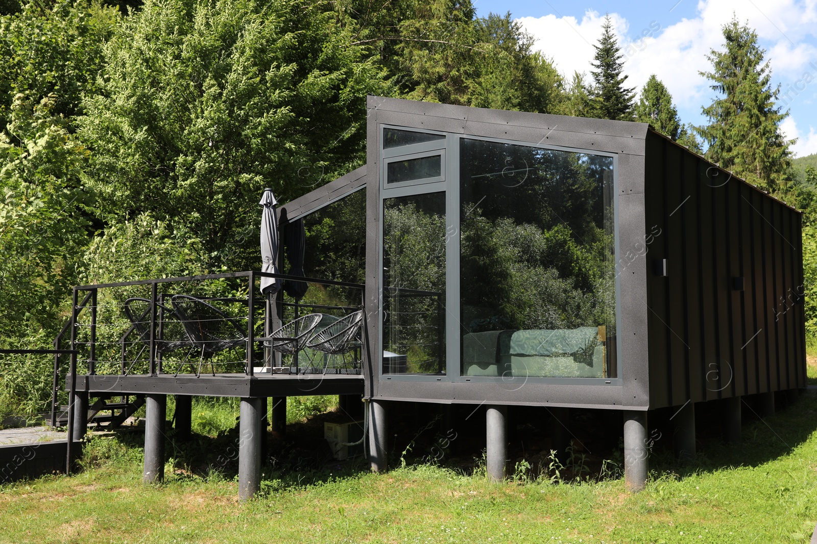 Photo of Stylish wooden cottage near forest at luxury resort