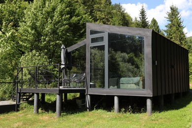 Photo of Stylish wooden cottage near forest at luxury resort