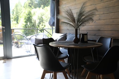 Photo of Table with decor and chairs in hotel room