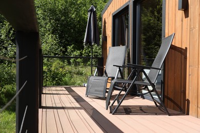 Photo of Cottage terrace with chairs on sunny day