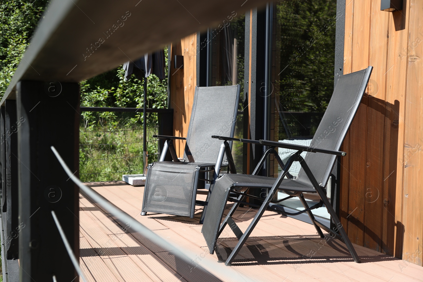 Cottage terrace with chairs on sunny day Photo of Cottage terrace with chairs on sunny day