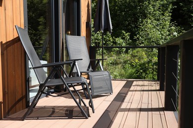Photo of Cottage terrace with chairs on sunny day
