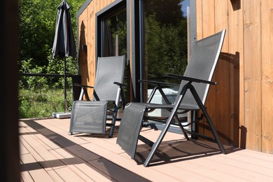 Photo of Cottage terrace with chairs on sunny day