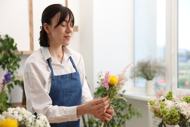 Photo of Florist making bouquet of flowers in shop
