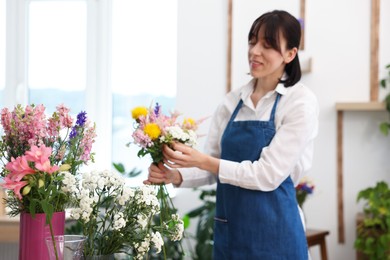 Photo of Florist making bouquet of flowers in shop