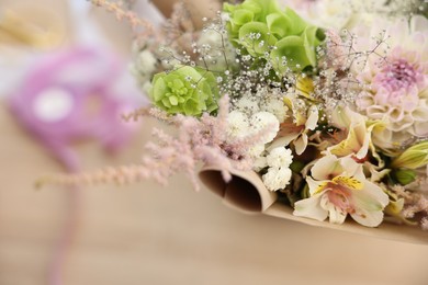 Photo of Beautiful bouquet of flowers on table in shop, closeup