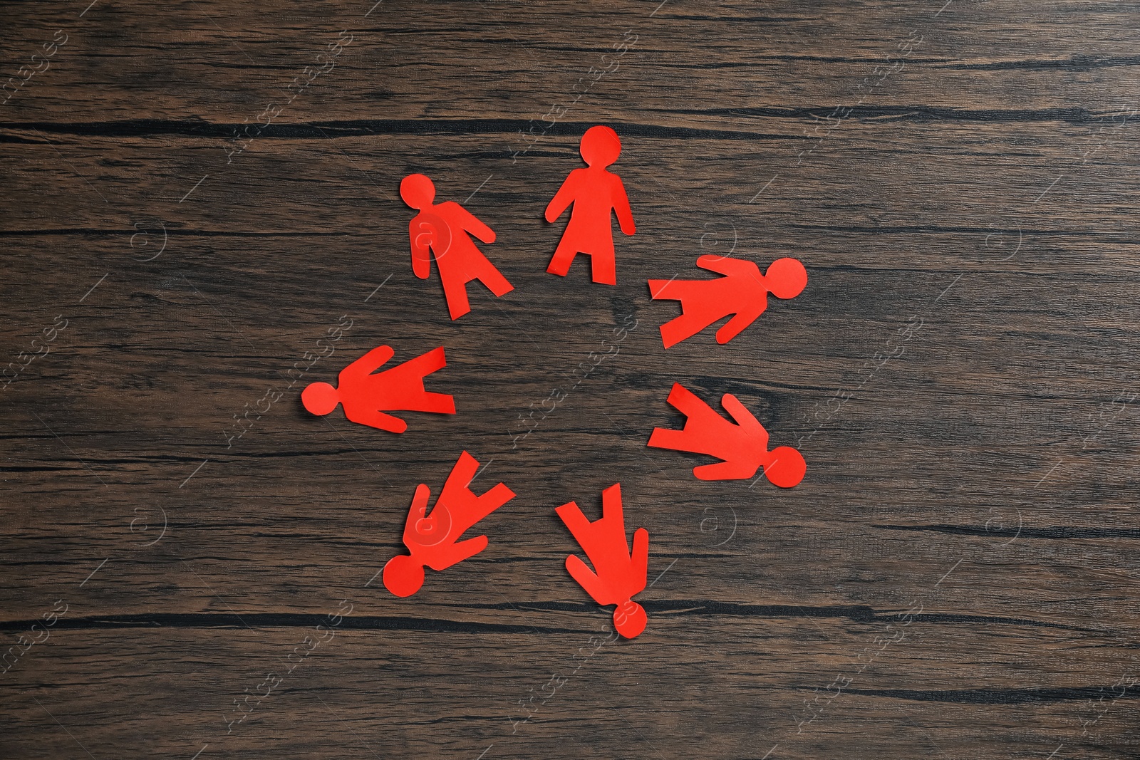 Human paper figures on wooden background, flat lay Photo of Human paper figures on wooden background, flat lay