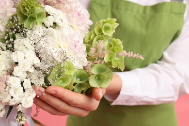 Photo of Florist with beautiful bouquet of flowers, closeup