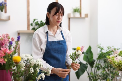 Photo of Florist making bouquet of flowers in shop