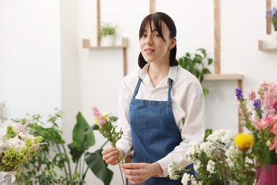 Photo of Florist making bouquet of flowers in shop