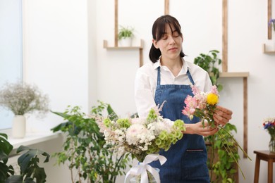Photo of Florist making bouquet of flowers in shop