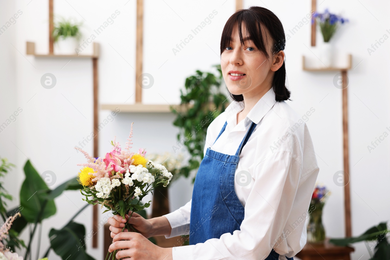 Florist making bouquet of flowers in shop Photo of Florist making bouquet of flowers in shop