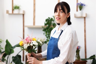 Photo of Florist making bouquet of flowers in shop