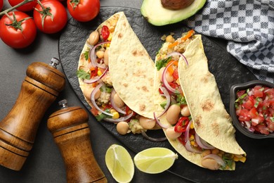 Photo of Tasty vegetarian tacos with beans and quinoa served on grey table, flat lay