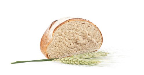 Photo of Piece of fresh bread and green wheat spikes isolated on white