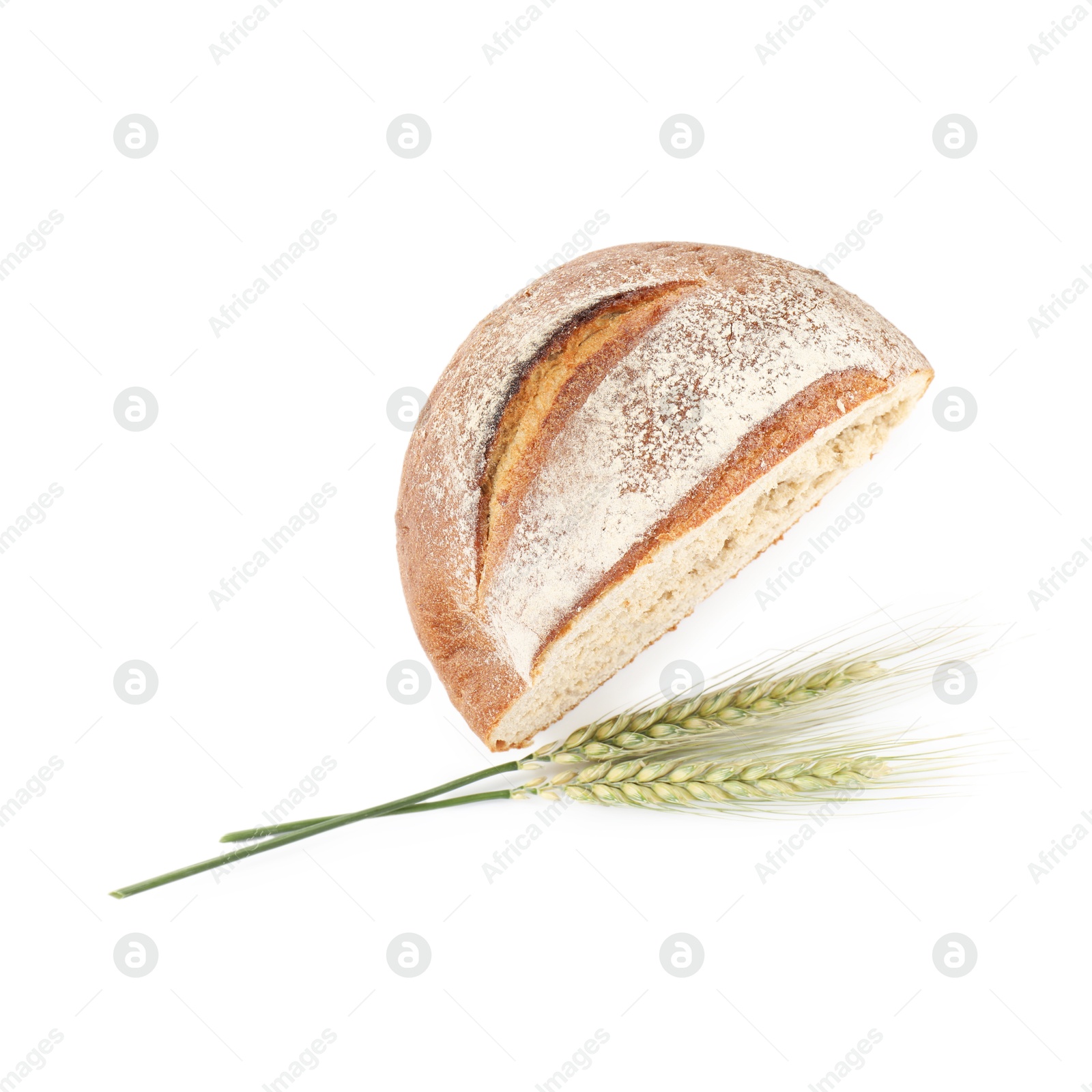 Photo of Piece of fresh bread and green wheat spikes isolated on white, top view