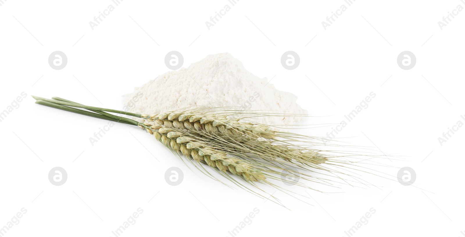 Photo of Pile of flour and green wheat spikes isolated on white