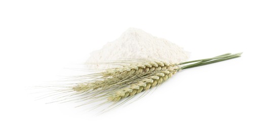 Photo of Pile of flour and green wheat spikes isolated on white