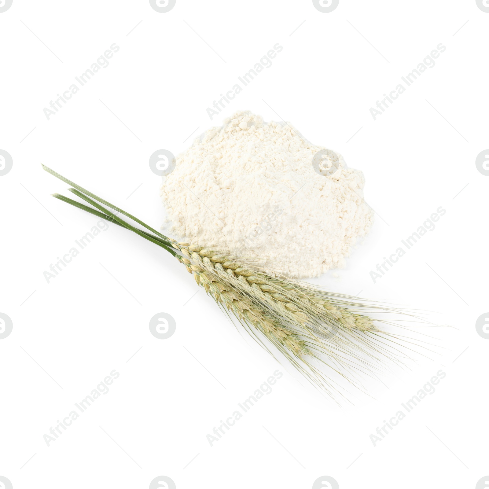 Photo of Pile of flour and green wheat spikes isolated on white, top view