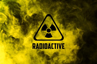Image of Radioactive sign and yellow toxic smoke against black background
