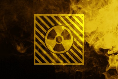 Image of Radioactive sign and yellow toxic smoke against black background
