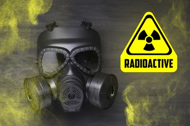 Image of Radiation threat. Gas mask, radioactive sign and smoke on grey wooden background, top view