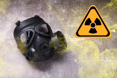 Image of Radiation threat. Gas mask, radioactive sign and smoke on grey background, top view